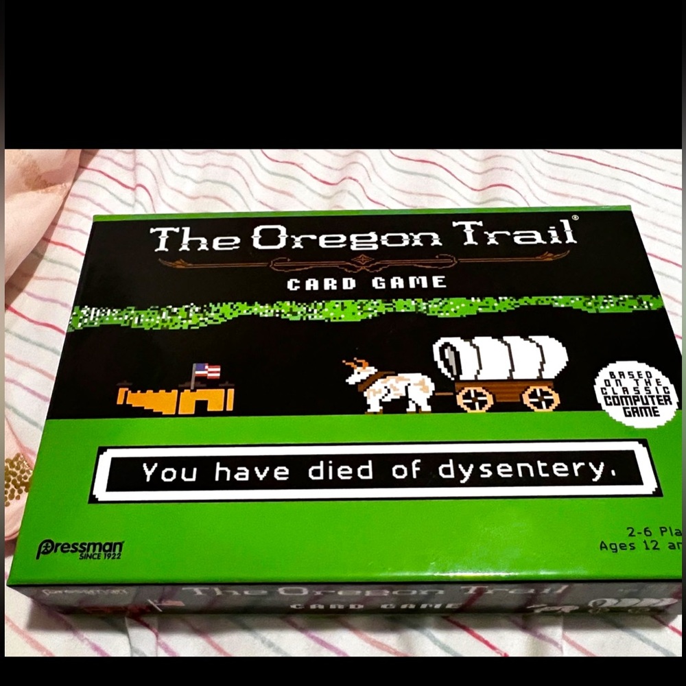 Oregon Trail Card Game - never opened(photo shows the tape still stuck to box)